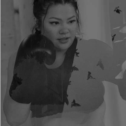 Model wearing the Swijin's Ultra Sports bra with boxing gloves in a gym setting